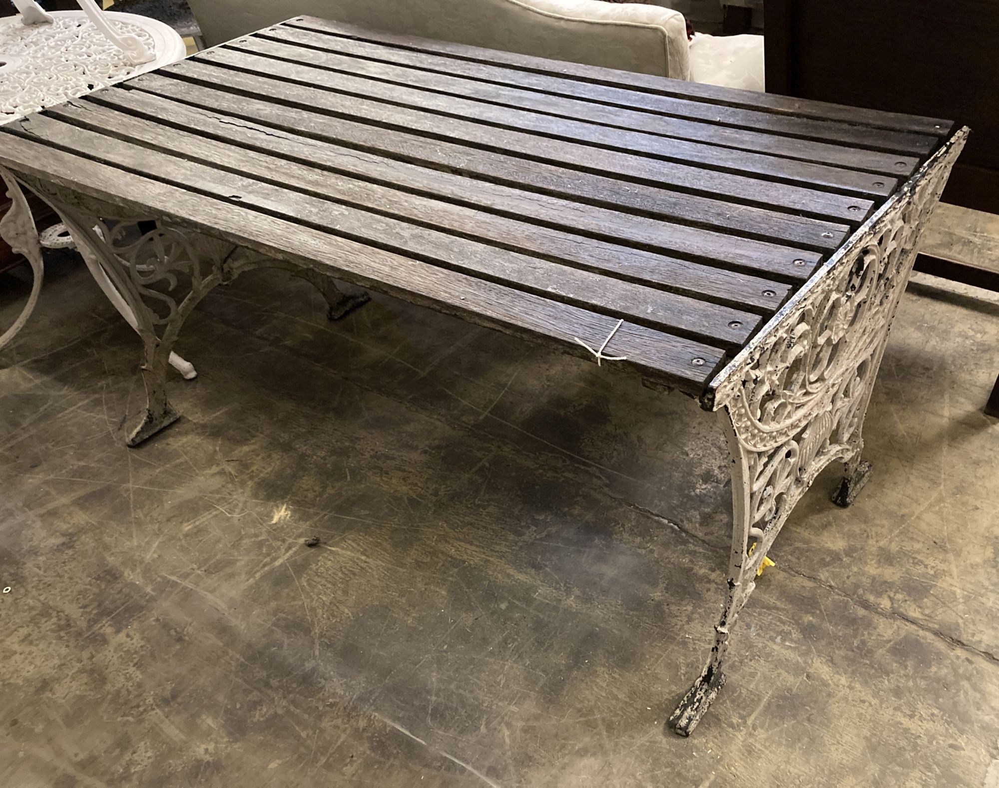 A Victorian style slatted rectangular cast metal base garden table, length 124cm, depth 68cm, height 64cm